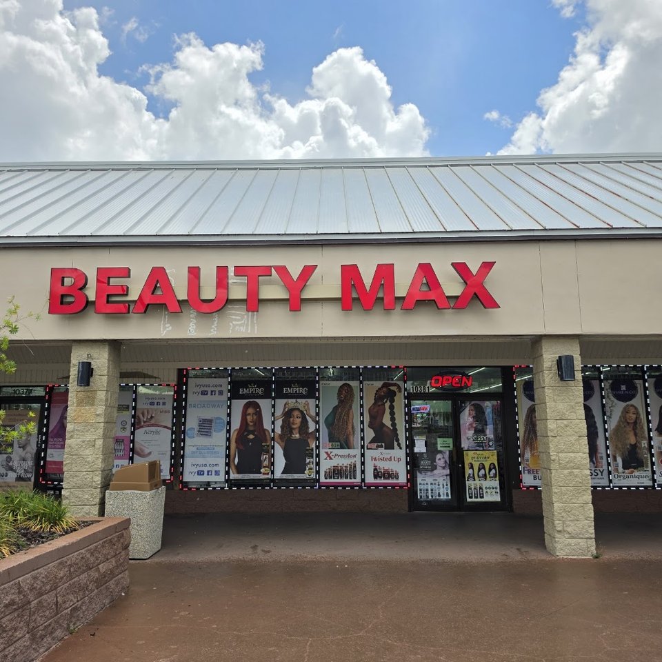 Beauty supply shelves with wigs, cosmetics, and hair products.